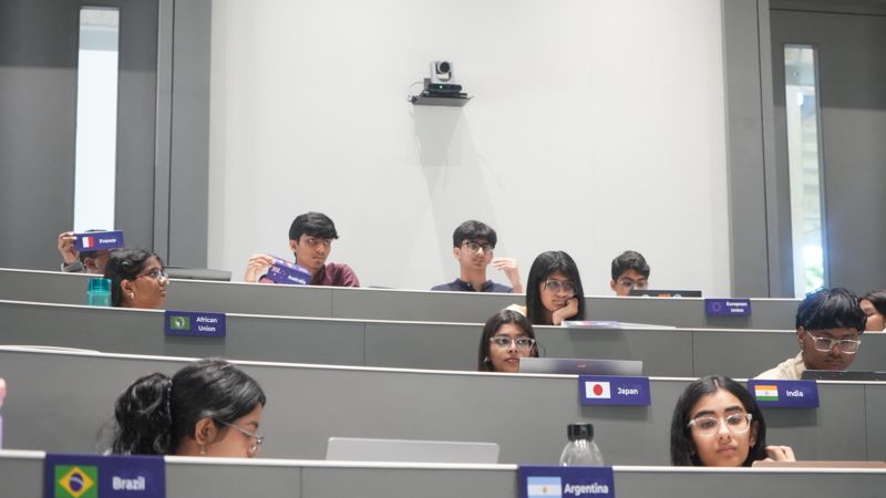 Delegates in committee behind their placards: France, African Union, Japan, India, Brazil and Argentina.