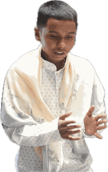 A delegate in a white kurta and shawl makes his case, both hands raised.